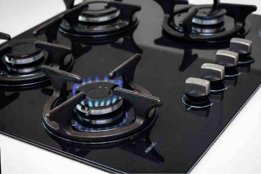 What are the pros and cons of glass top cooktops compared to traditional gas stoves_
